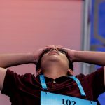 Dhroov Bharatia, 13, from Plano, Texas, reacts as he answers a question correctly during the Scripps National Spelling Bee, Wednesday, June 1, 2022, in Oxon Hill, Md. (AP Photo/Andrew Harnik)