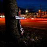 
              This long exposure photo shows traffic driving on Roosevelt Boulevard by a makeshift memorial for Samara Banks and her three children who were struck and killed by a car in 2013, in Philadelphia, Wednesday, May 25, 2022. (AP Photo/Matt Rourke)
            
