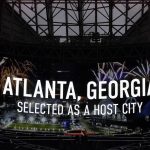 
              Mercedes-Benz Stadium displays an announcement that FIFA has selected Atlanta as a 2026 soccer World Cup host city, Thursday, June 16, 2022, in Atlanta. (AP Photo/Brynn Anderson)
            