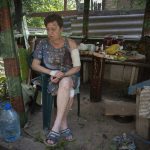 
              A woman injured when her house was damaged by the Russian shelling sits shocked in the yard of her house in Bakhmut, Donetsk region, Ukraine, Sunday, June 26, 2022.(AP Photo/Efrem Lukatsky)
            