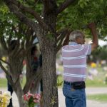 
              A man watches a burial service for Irma Garcia and husband, Joe Garcia, at Hillcrest Cemetery Wednesday, June 1, 2022, in Uvalde, Texas. Irma Garcia was killed in last week's elementary school shooting. Joe Garcia died two days later. (AP Photo/Jae C. Hong)
            