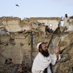 
              Afghans stand among destruction after an earthquake in Gayan village, in Paktika province, Afghanistan, Thursday, June 23, 2022. A powerful earthquake struck a rugged, mountainous region of eastern Afghanistan early Wednesday, flattening stone and mud-brick homes in the country's deadliest quake in two decades, the state-run news agency reported. (AP Photo/Ebrahim Nooroozi)
            