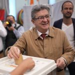 
              Hard-left figure Jean-Luc Melenchon casts his ballot in the first round of the parliamentary election, Sunday, June 12, 2022 in Marseille, southern France. French voters are choosing lawmakers in a parliamentary election as President Emmanuel Macron seeks to secure his majority while under growing threat from a leftist coalition. (AP Photo/Daniel Cole)
            