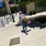 
              CORRECTS YEAR TO 2022 - A woman carrying a pair of pink shoes walks near the Sept. 11 memorial in New York in this Monday, June 6, 2022 iPhone photo. "Sometimes I feel that photography has almost lost the magic thing that it had before the means to take a photo and share it with the world was in our pocket," wrote Marti. (AP photo/Enric Marti)
            