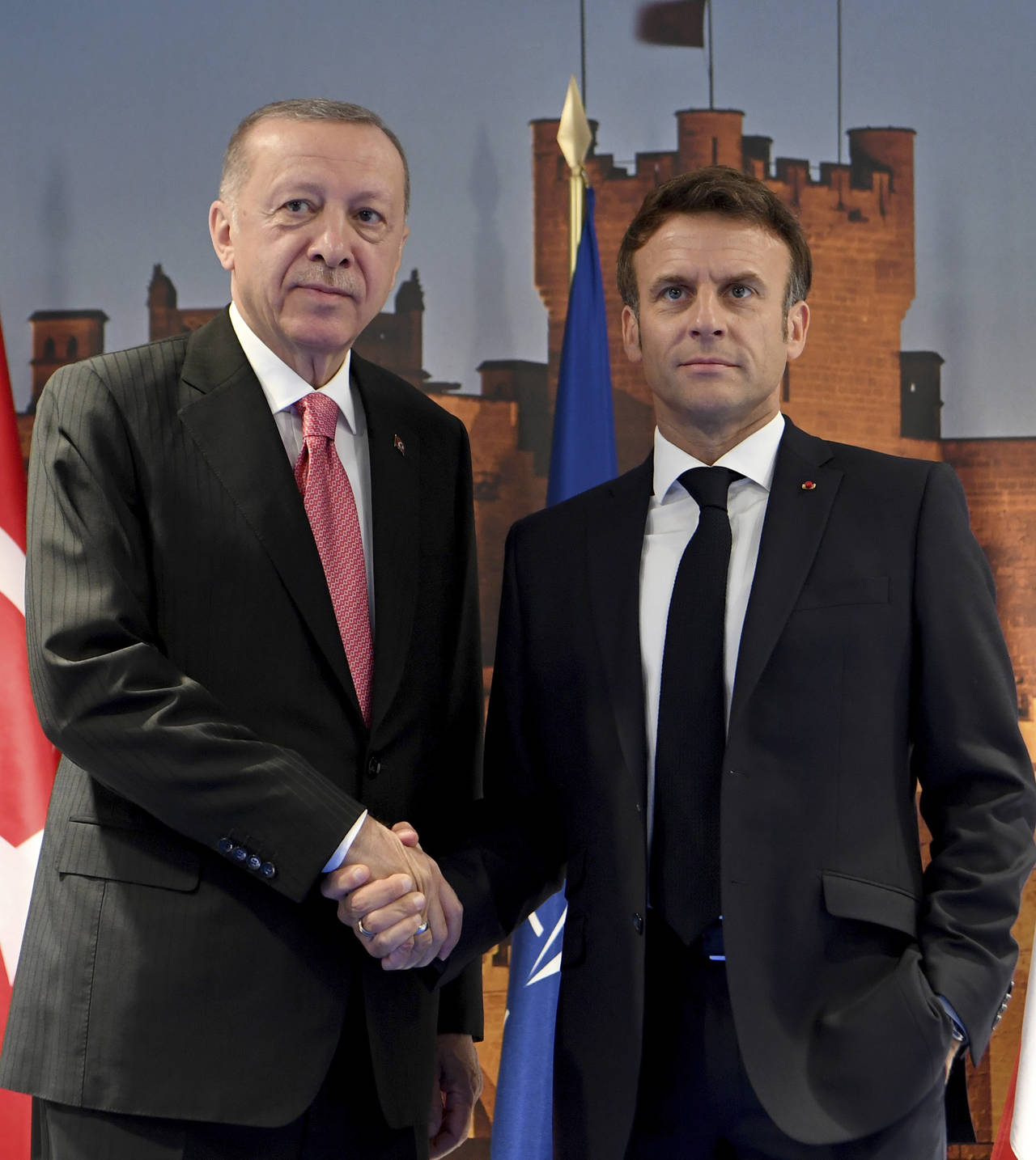 France's President Emmanuel Macron, right, and Turkey's President Recep Tayyip Erdogan shake hands ...