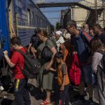 
              People board an evacuation train in Pokrovsk railway station, eastern Ukraine, Friday, June 10, 2022. (AP Photo/Bernat Armangue )
            