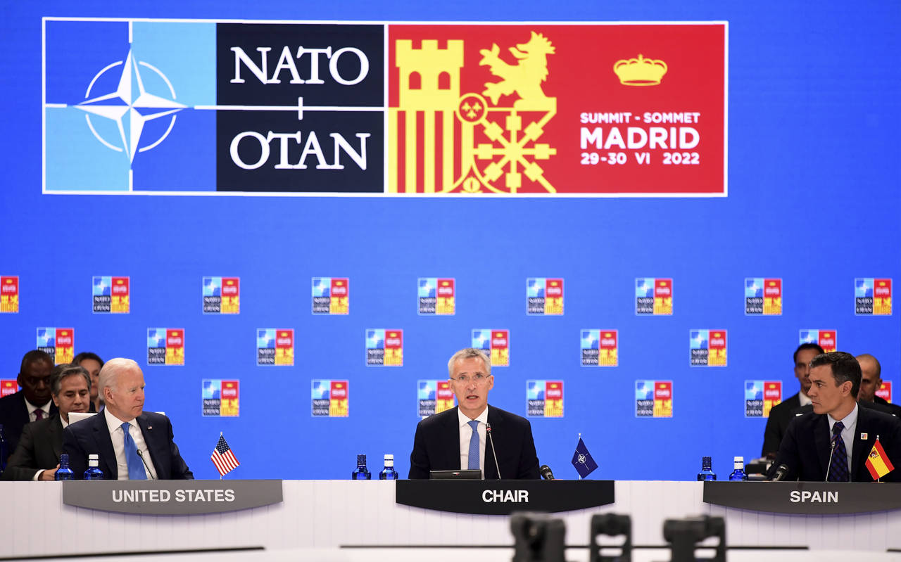 NATO Secretary General Jens Stoltenberg center, flanked by Spanish Prime Minister Pedro Sanchez, ri...