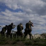 
              Civilian militia men hold rifles during training at a shooting range in outskirts Kyiv, Ukraine, Tuesday, June 7, 2022. (AP Photo/Natacha Pisarenko)
            
