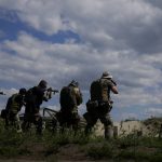 
              Civilian militia men hold shotguns during training at a shooting range in outskirts Kyiv, Ukraine, Tuesday, June 7, 2022. (AP Photo/Natacha Pisarenko)
            