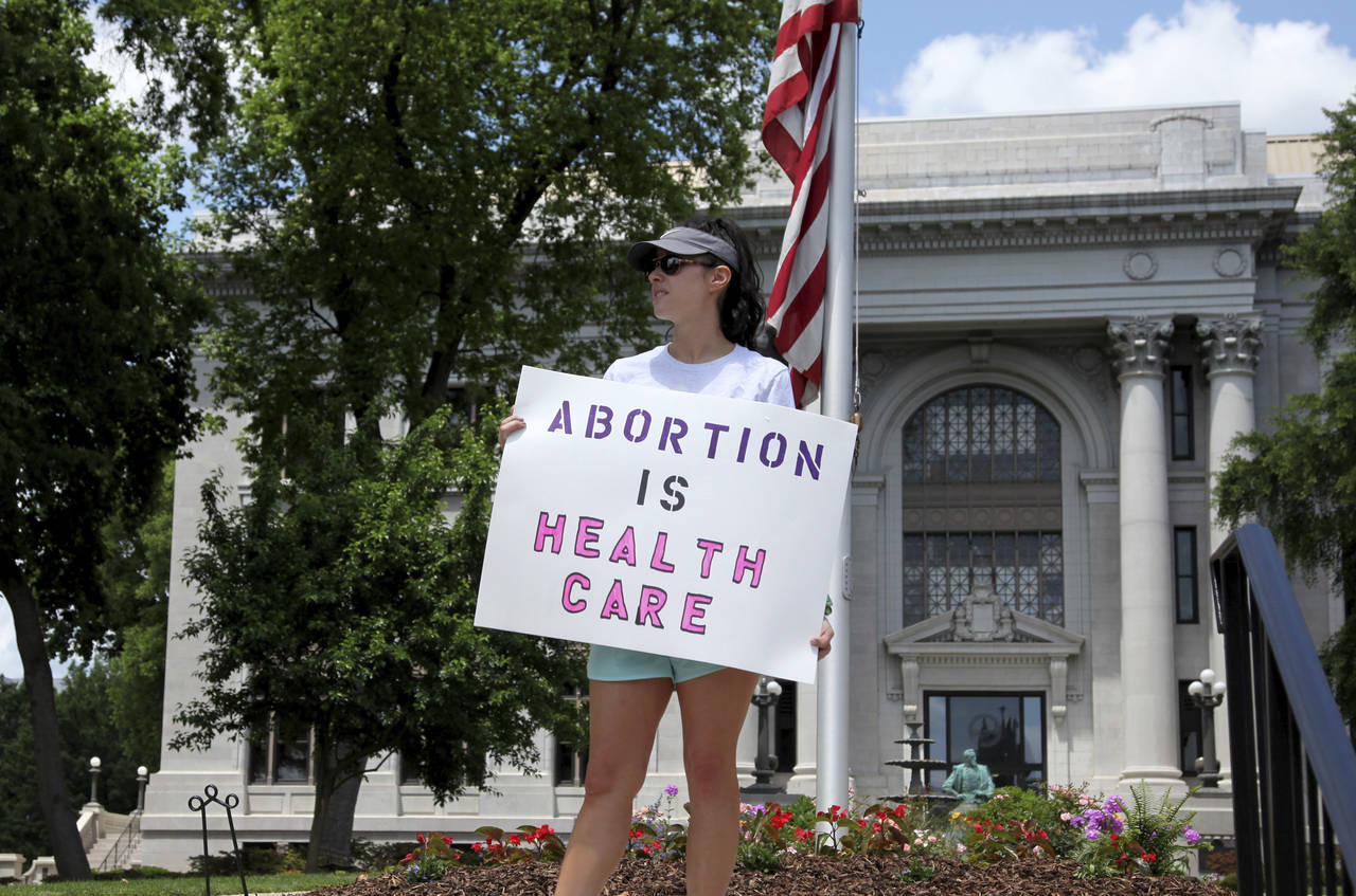 FILE - Abortion-rights demonstrator Jessica Smith holds a sign in front of the Hamilton County Cour...