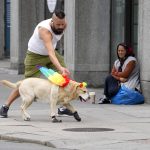 
              A man walks with a dog decorated with rainbow wings near the scene of a shooting in central of Oslo, Norway, Sunday, June 26, 2022. A gunman opened fire in Oslo’s nightlife district early Saturday, killing two people and leaving more than 20 wounded in what the Norwegian security service called an "Islamist terror act" during the capital’s annual LGBTQ Pride festival. (AP Photo/Sergei Grits)
            