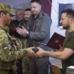 
              In this photo provided by the Ukrainian Presidential Press Office on Saturday, June 18, 2022, Ukrainian President Volodymyr Zelenskyy, right, awards a serviceman as he visits the war-hit Mykolaiv region. (Ukrainian Presidential Press Office via AP)
            