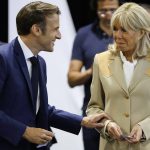
              France's President Emmanuel Macron talks to his wife Brigitte Macron before voting in the first round of French parliamentary election at a polling station in Le Touquet, northern France, Sunday June 12, 2022. French voters are choosing lawmakers in a parliamentary election Sunday as President Emmanuel Macron seeks to secure his majority while under growing threat from a leftist coalition. (Ludovic Marin, Pool via AP)
            