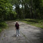 Mark Delaney, Mayor of Village of the Branch, a village in the Town of Smithtown in Suffolk County, walks along Old Route 111, now serving as a walking path used by residents to avoid the precarious major thoroughfare nearby, Thursday, June 2, 2022, in Smithtown, N.Y. From small towns to big cities, every government across the U.S. was offered a slice of $350 billion of federal coronavirus relief funds intended to help shore up their finances, fight the virus and invest in community projects. Nearly 1,500 local government said "no," turning down a total of about $60 million of aid, according to an Associated Press analysis. At least few later regretted the decision, wishing with hindsight that they had taken the money. (AP Photo/John Minchillo)