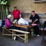 
              A family cooks outdoors due to lack of electricity and gas next to a residential building damaged in a Russian bombing in Bakhmut, eastern Ukraine, Monday, May 30, 2022. In towns and cities near the fighting in eastern Ukraine, artillery and missile strikes have downed power lines and punched through water pipes, leaving many without electricity or water as repair crews race to repair the damage. (AP Photo/Francisco Seco)
            