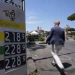 
              File - A man walks past a petrol station price board in central Rome, Wednesday, June 15, 2022.People all over the world are confronting higher fuel prices as the war in Ukraine and lagging output from producing nations drive prices higher. Higher pump prices are pushing some to walk, bike or use trains, more or simply travel less. (AP Photo/Alessandra Tarantino, File)
            