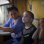 
              People evacuated from the war hit area sit inside an evacuation train waiting for departure in Pokrovsk, eastern Ukraine, Saturday, June 11, 2022. (AP Photo/Efrem Lukatsky)
            