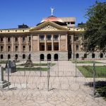 After multiple nights of abortion-rights protests, security fences and barbed wire surround the Arizona Capitol, Monday, June 27, 2022, in Phoenix. (AP Photo/Ross D. Franklin)