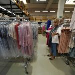 
              Nadia Zanola, chairman of the Cose di Maglia factory and owner of the D.Exterior brand, gestures as she goes through racks of clothing at a warehouse section of unsold clothes, in Brescia, Italy, Tuesday, June 14, 2022. Small Italian fashion producers are still allowed to export to Russia, despite sanctions, as long as the wholesale price is under 300 euros. But they are having a hard time getting paid, due to restrictions tied to the financial sector. (AP Photo/Luca Bruno)
            