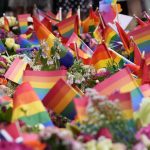 
              Flowers and rainbow flags are placed at the scene of a shooting in central Oslo, Norway, Saturday, June 25, 2022. Norwegian police say they are investigating an overnight shooting in Oslo that killed two people and injured more than a dozen as a case of possible terrorism. In a news conference Saturday, police officials said the man arrested after the shooting was a Norwegian citizen of Iranian origin who was previously known to police but not for major crimes. (AP Photo/Sergei Grits)
            