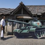 
              A young exile Tibetan stands in front of a cardboard cutout of a tank to replicate the 'tank man', an iconic moment in the Tiananmen Square pro-democracy protests in 1989, in Dharmsala, India, Saturday, June 4, 2022. Saturday marks the anniversary of China’s bloody 1989 crackdown on pro-democracy protests at Beijing’s Tiananmen Square. (AP Photo/Ashwini Bhatia)
            