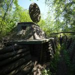 
              A foreign journalist checks a captured Ukrainian checkpoint with well-fortified trenches near Schastia town, on the territory which is under the Government of the Luhansk People's Republic control, eastern Ukraine, Saturday, June 11, 2022. This photo was taken during a trip organized by the Russian Ministry of Defense. (AP Photo)
            