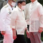
              Incoming Philippine president Ferdinand Marcos Jr., right, and outgoing President Rodrigo Duterte, center, attend Marcos' inauguration ceremony at the Malacanang Presidential Palace grounds in Manila, Philippines, Thursday, June 30, 2022. Marcos, the son of the late president Ferdinand Marcos has been sworn in as the Philippine president. (Francis R. Malasig/Pool Photo via AP)
            