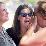 Brandy Bock, center, best friend of Vicki Lynne Hoskinson's older sister, shouts "evil is gone" after an emotional hug with fellow supporters and Tucson community members following the announcement of Frank Atwood's execution , Wednesday, June 8, 2022, outside of Arizona State Prison Complex- Florence in Florence, Ariz. Atwood, 66, died by lethal injection on Wednesday at the state prison for his murder conviction in the killing of Hoskinson, whose body was found in the desert. (Rebecca Sasnett/Arizona Daily Star via AP)