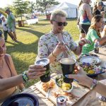 
              Festivalgoers are seen during Bonnaroots, a four course meal that benefits global organizations for hunger, presented by Eat for Equity at the Bonnaroo Music and Arts Festival on Thursday, June 16, 2022, in Manchester, Tenn. (Photo by Amy Harris/Invision/AP)
            