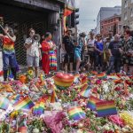 
              Flowers are left as a spontaneous pride parade arrives at the scene of a shooting in central Oslo, Saturday, June 25, 2022. Norwegian police say they are investigating an overnight shooting in Oslo that killed two people and injured more than a dozen as a case of possible terrorism. In a news conference Saturday, police officials said the man arrested after the shooting was a Norwegian citizen of Iranian origin who was previously known to police but not for major crimes. (Håkon Mosvold Larsen/NTB Scanpix via AP)
            