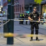 
              Police stand guard at the site of a mass shooting in Oslo, early Saturday, June 25, 2022. A few people were killed and more than a dozen injured early Saturday in a mass shooting in Oslo, Norwegian police said, as the city was gearing up for an annual Pride parade. (Javad M. Parsa/NTB via AP)
            