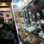 
              A customer views an array of paraphernalia used to smoke marijuana at the Highland Cafe in Bangkok, Thailand, Thursday, June 9, 2022. Measures to legalize cannabis became effective Thursday, paving the way for medical and personal use of all parts of cannabis plants, including flowers and seeds. (AP Photo/Sakchai Lalit)
            