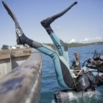 
              Coral reef restoration ranger Dosa Mshenga Mchambi heads into the Indian Ocean to place artificial reef structure near Shimoni, Kenya on Tuesday, June 14, 2022. The marine area off the coast of Kenya at Wasini Island, jointly managed by a foundation and the island's community, has been planting over 8,000 corals a year since early 2010s and placed about 800 artificial reef structures in the channel in a bid to restore Wasini's coral gardens.  (AP Photo/Brian Inganga)
            