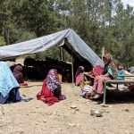 
              Afghan villagers sit outside a tent after their house was damaged in an earthquake in the Spera District of the southwestern part of Khost Province, Afghanistan, Wednesday, June 22, 2022. A powerful earthquake struck a rugged, mountainous region of eastern Afghanistan early Wednesday, killing at least 1,000 people and injuring 1,500 more in one of the country's deadliest quakes in decades, the state-run news agency reported. (AP Photo)
            