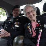 
              British veterans Roy Maxwell and Mary Scott arrive in a British Taxi Charity for Military Veterans to the ceremony at Pegasus Bridge, in Ranville, Normandy, Sunday, June, 5, 2022. On Monday, the Normandy American Cemetery and Memorial, home to the gravesites of 9,386 who died fighting on D-Day and in the operations that followed, will host U.S. veterans and thousands of visitors in its first major public ceremony since 2019. (AP Photo/Jeremias Gonzalez)
            