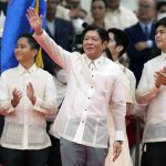 
              President Ferdinand "Bongbong" Marcos Jr., center, greet after being sworn in by Supreme Court Chief Justice Alexander Gesmundo during the inauguration ceremony at National Museum on Thursday, June 30, 2022 in Manila, Philippines. Marcos was sworn in as the country's 17th president. (AP Photo/Aaron Favila)
            