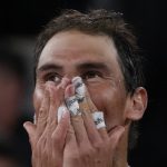 
              Spain's Rafael Nadal celebrates winning his quarterfinal match against Serbia's Novak Djokovic in four sets, 6-2, 4-6, 6-2, 7-6 (7-4), at the French Open tennis tournament in Roland Garros stadium in Paris, France, Wednesday, June 1, 2022. (AP Photo/Christophe Ena)
            