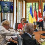 
              From left, Britain's Prime Minister Boris Johnson, Japan's Prime Minister Fumio Kishida, European Commission President Ursula von der Leyen, US President Joe Biden, European Council President Charles Michel before a round table as Ukraine President Volodymyr Zelenskyy appears on screen to address the G7 leaders via video link during their working session at Castle Elmau in Kruen, near Garmisch-Partenkirchen, Germany, on Monday, June 27, 2022. The Group of Seven leading economic powers are meeting in Germany for their annual gathering Sunday through Tuesday. (Kenny Holston/Pool via AP)
            