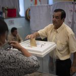 
              A man casts his ballot in the first round of the French parliamentary election, Sunday, June 12, 2022 in Marseille, southern France. Voters are choosing lawmakers as President Emmanuel Macron seeks to secure his majority while under growing threat from a leftist coalition. (AP Photo/Daniel Cole)
            