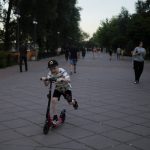 
              A child rides a scooter at Natalka Park in Kyiv, Ukraine, Tuesday, June 7, 2022. (AP Photo/Natacha Pisarenko)
            