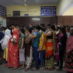 
              People crowd the registration counter at Tej Bahadur Sapru Hospital in Prayagraj, Uttar Pradesh state, India, Thursday, June 23, 2022. The hospital is experiencing heavy rush this summer with several patients turning up with heat related ailments. (AP Photo/Rajesh Kumar Singh)
            