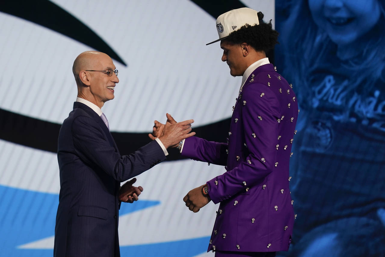 Paolo Banchero, right, is congratulated by NBA Commissioner Adam Silver after being selected as the...