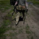 
              A civilian militia man holds a shotgun and a rifle during training at a shooting range in outskirts Kyiv, Ukraine, Tuesday, June 7, 2022. (AP Photo/Natacha Pisarenko)
            