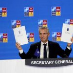
              NATO Secretary General Jens Stoltenberg holds up a letter of commitment to innovation at a NATO summit in Madrid, Spain on Thursday, June 30, 2022. North Atlantic Treaty Organization heads of state will meet for the final day of a NATO summit in Madrid on Thursday. (AP Photo/Paul White)
            