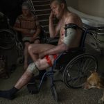 
              A Ukrainian injured serviceman and an injured civilian wait for medical treatment in the Donetsk region, eastern Ukraine, Tuesday, June 7, 2022. (AP Photo/Bernat Armangue)
            