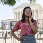 Alexandra McPhee, 29, of Arlington, Va., poses for a portrait while protesting outside the Supreme Court about abortion with the advocacy group, Concerned Women for America, where she is the director of government relations, Wednesday, June 15, 2022, in Washington. The 29-year old came to the court to protest in favor of Roe V. Wade's overturning along with the anti-abortion advocacy group Concerned Women for America. "I want to be out here to show that this is an issue that I care about that I believe is helpful for all women, all families, to have more protections for life than there are now. And this decision will make that possible." (AP Photo/Jacquelyn Martin)