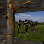 
              Civilian militia men hold shotguns during training at a shooting range in outskirts Kyiv, Ukraine, Tuesday, June 7, 2022. (AP Photo/Natacha Pisarenko)
            