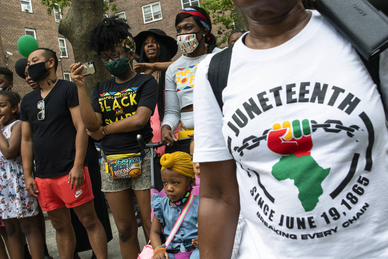 FILE - People attend Juneteenth celebrations in the Harlem neighborhood of New York, on June 19, 20...