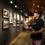 Clark Little, a wave photographer from the North Shore of Oahu, speaks during an interview at his gallery in Haleiwa, Hawaii, Friday, May 13, 2022. (AP Photo/Caleb Jones)