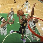 
              Golden State Warriors guard Stephen Curry (30) goes up for a shot against Boston Celtics center Al Horford (42) and guard Derrick White (9) during Game 4 of basketball's NBA Finals, Friday, June 10, 2022, in Boston. (Kyle Terada/Pool Photo via AP)
            